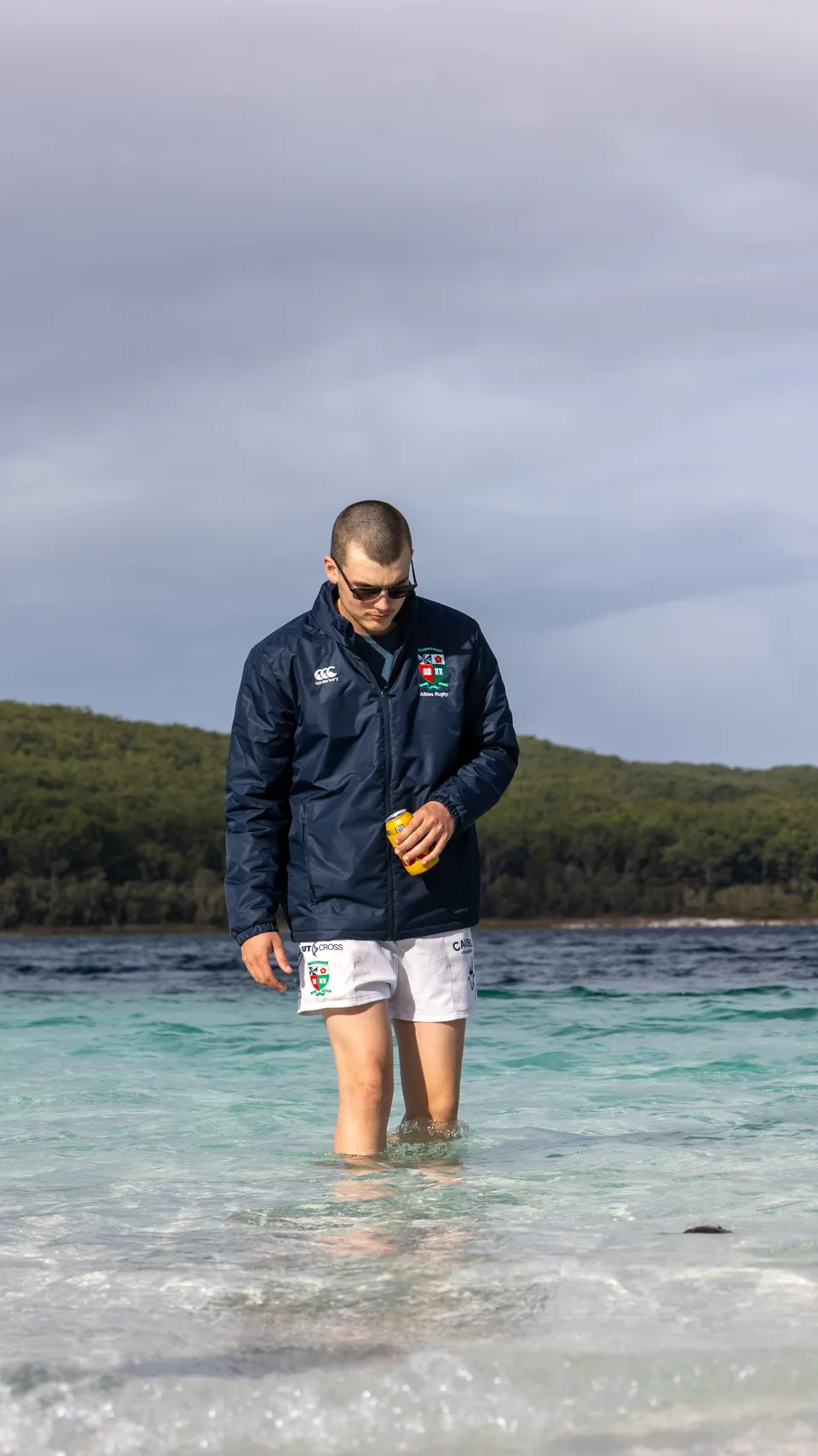 Man standing in shallow water at the shoreline