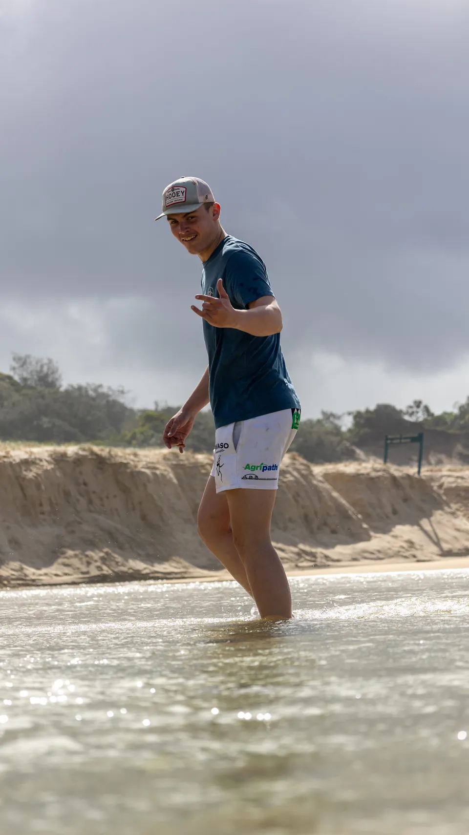 Man wading through clear shallow water