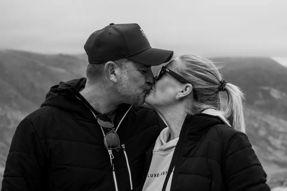 Black and white photograph of a couple by a lake in Queenstown