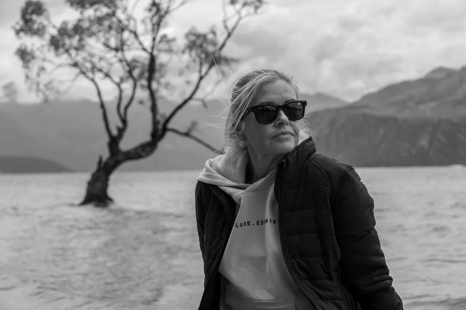 Black and white portrait of a woman beside a lake